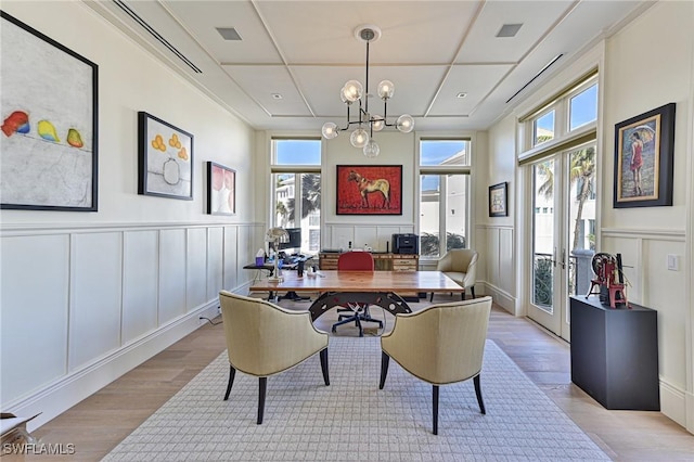 dining room featuring french doors, visible vents, and light wood-type flooring