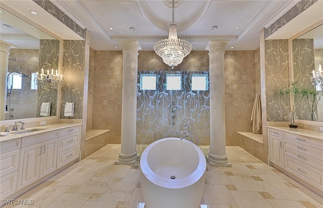 bathroom with a freestanding tub and ornate columns