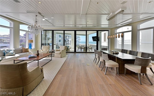 sunroom / solarium featuring wood ceiling and a chandelier