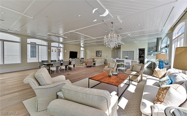 living area with a chandelier and wood finished floors