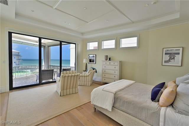 104 Bonaire Ln, Bonita Springs, FL 34134 - bedroom with a water view, a tray ceiling, access to outside, and wood finished floors