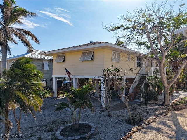 back of property featuring stairs