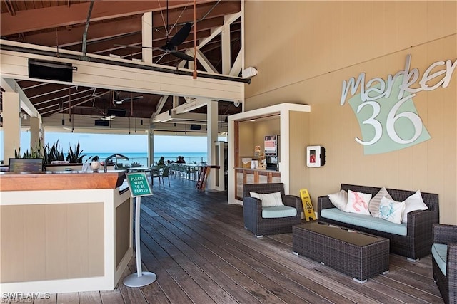 wooden deck with a ceiling fan, an outdoor living space, a water view, and outdoor dry bar