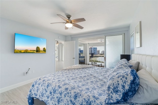 bedroom featuring light wood-style flooring, baseboards, access to outside, and a ceiling fan