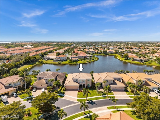 drone / aerial view with a residential view and a water view