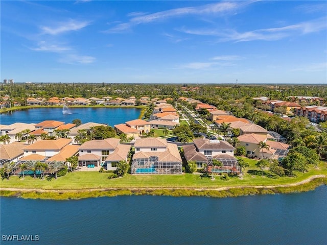 drone / aerial view with a residential view and a water view