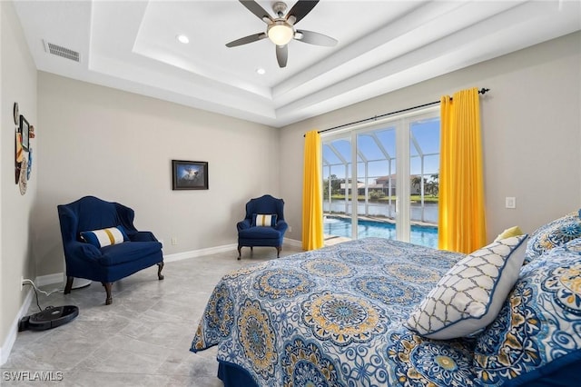 bedroom featuring visible vents, a raised ceiling, a ceiling fan, baseboards, and access to exterior