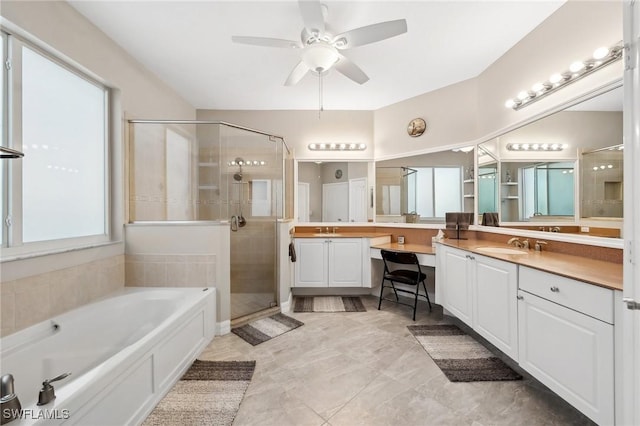 bathroom featuring a bath, a stall shower, vanity, and ceiling fan