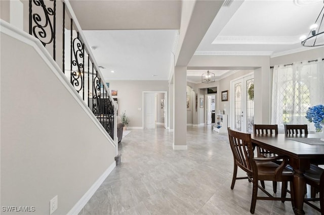 dining space featuring stairs, an inviting chandelier, baseboards, and ornamental molding