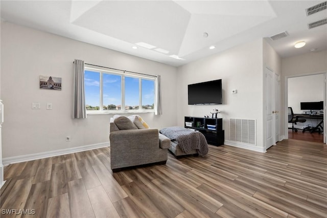 living room with baseboards, visible vents, and light wood-type flooring