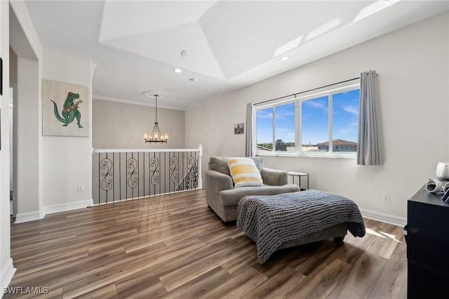 bedroom featuring vaulted ceiling, wood finished floors, baseboards, and a chandelier