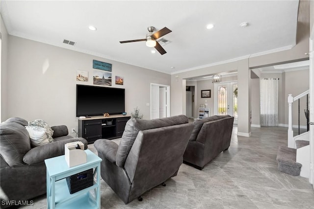 living room featuring visible vents, stairs, crown molding, and ceiling fan