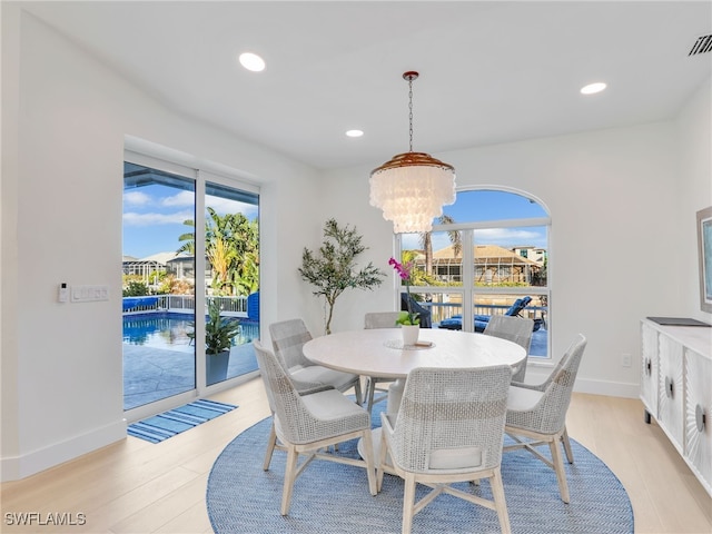 dining space featuring recessed lighting, plenty of natural light, and light wood-style floors