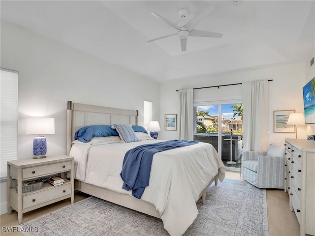 bedroom with visible vents, a tray ceiling, ceiling fan, access to outside, and light wood-type flooring