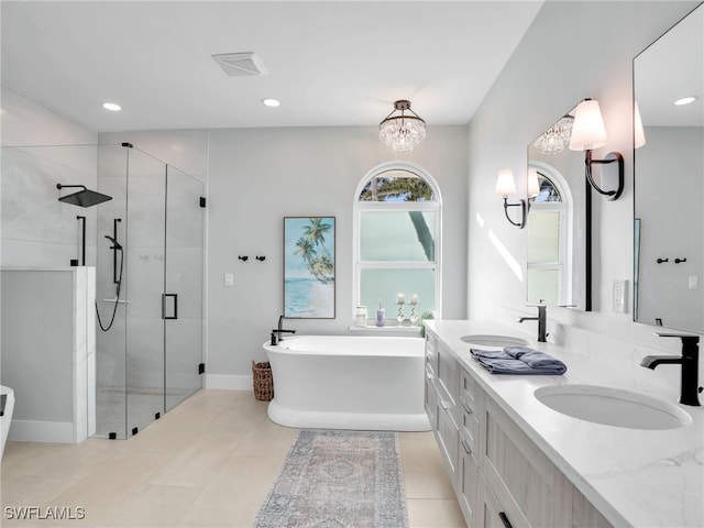 bathroom featuring a sink, a freestanding bath, and a shower stall