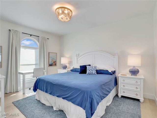 bedroom featuring light wood-type flooring and baseboards