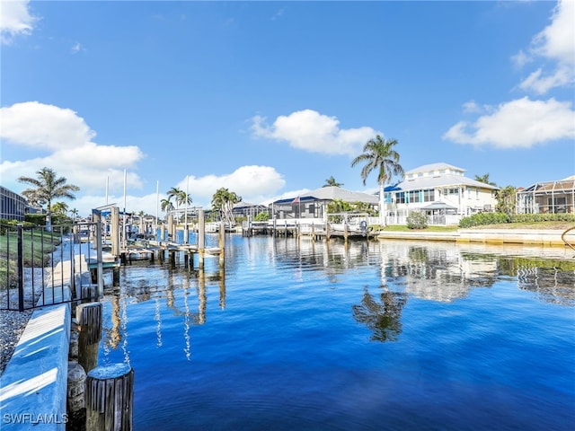 dock area featuring a water view, a residential view, and boat lift