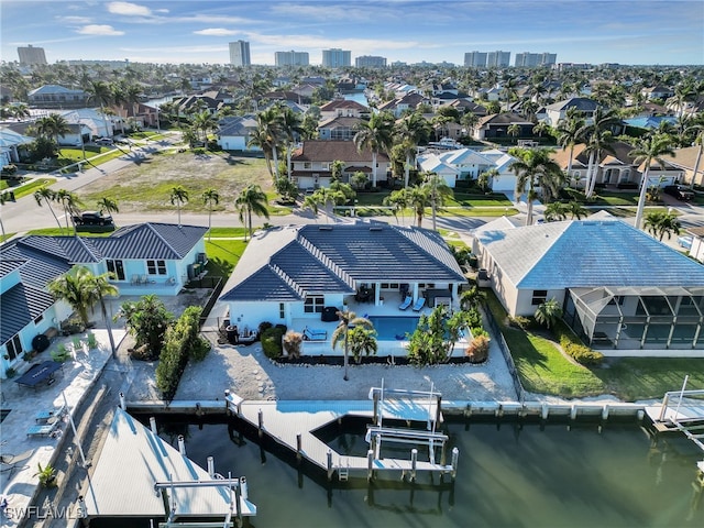 drone / aerial view featuring a residential view and a water view