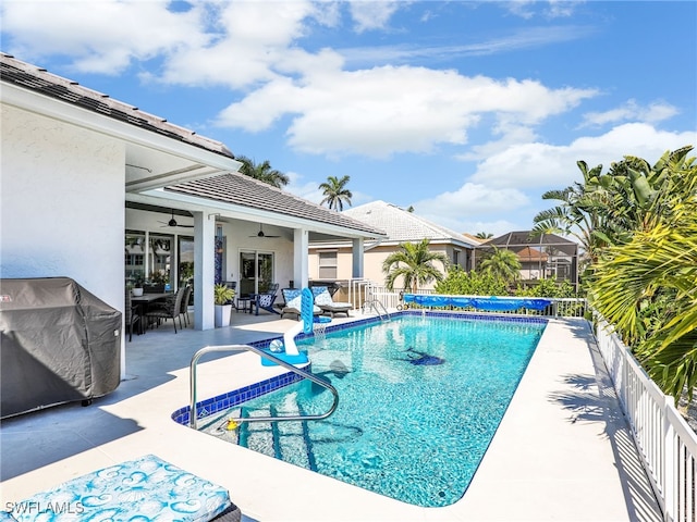 view of swimming pool featuring a fenced in pool, a patio, and ceiling fan