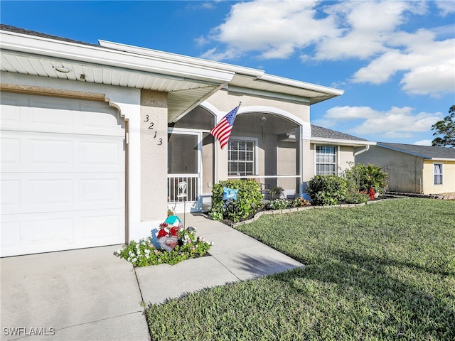 view of front facade with a garage and a front lawn