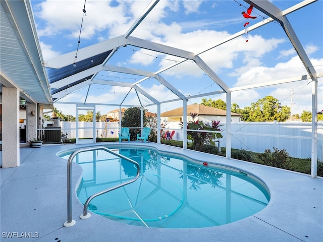 view of swimming pool with a lanai and a patio area