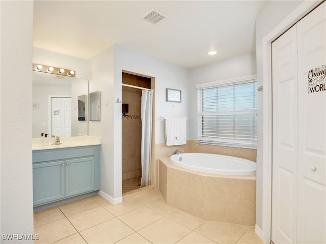 bathroom with tile patterned floors, shower with separate bathtub, and vanity