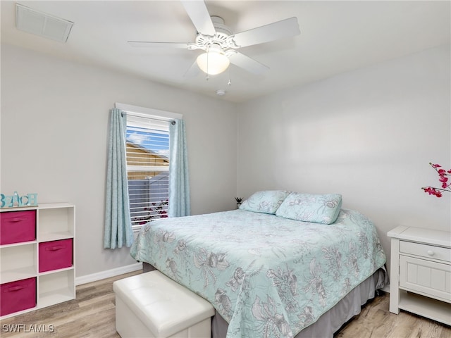 bedroom with light hardwood / wood-style floors and ceiling fan