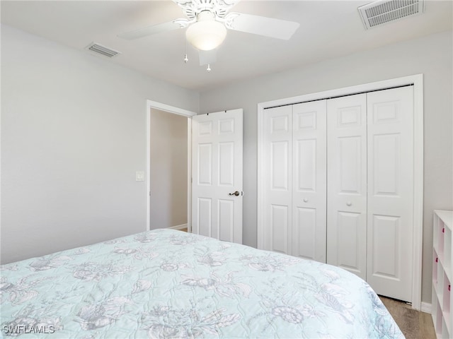 bedroom with ceiling fan and a closet