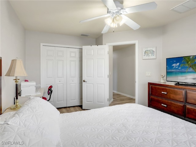 bedroom featuring a closet, ceiling fan, and light wood-type flooring