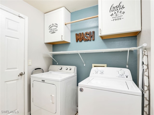 laundry area featuring cabinets and independent washer and dryer