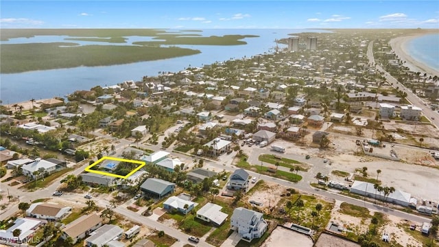 birds eye view of property featuring a water view and a view of the beach