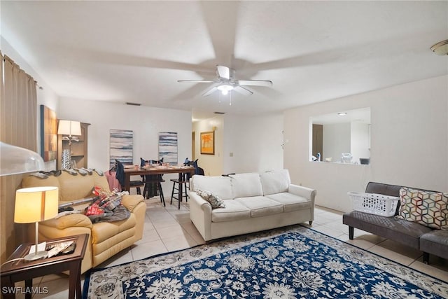 tiled living room with ceiling fan