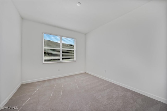 unfurnished room featuring light colored carpet