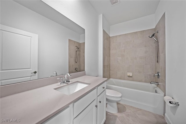 full bathroom featuring tile patterned floors, toilet, tiled shower / bath combo, and vanity