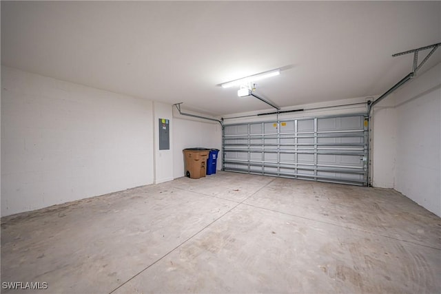 garage with a garage door opener and electric panel