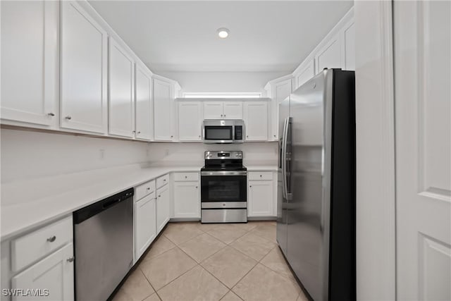 kitchen with white cabinetry, light tile patterned floors, and appliances with stainless steel finishes