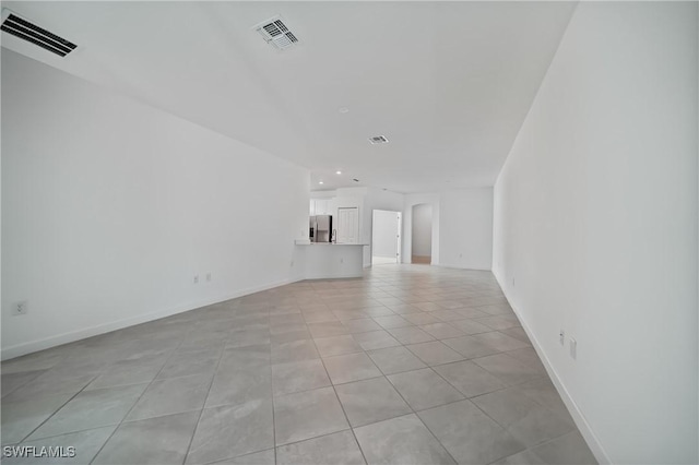 unfurnished living room featuring light tile patterned floors