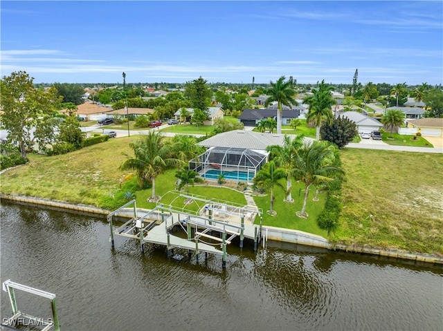 drone / aerial view with a water view and a residential view