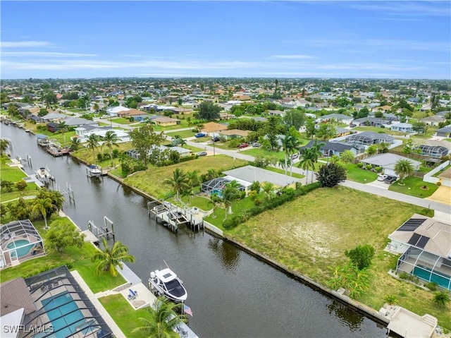 birds eye view of property with a water view and a residential view