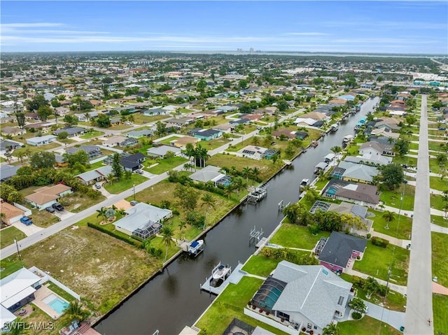 bird's eye view featuring a water view and a residential view