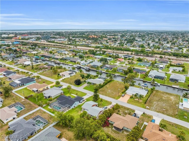 birds eye view of property featuring a water view and a residential view