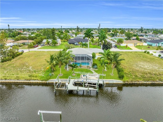 birds eye view of property featuring a water view and a residential view