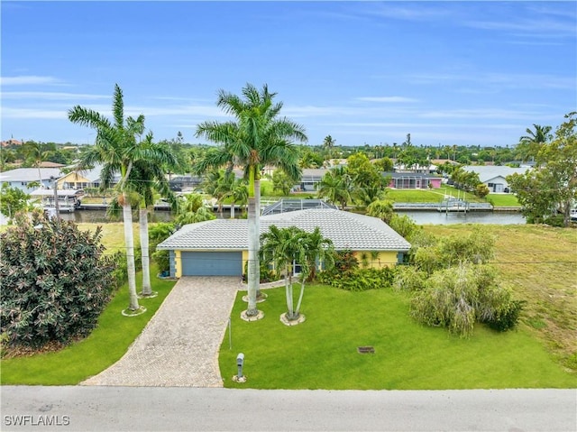 view of front facade featuring a water view, a residential view, and a front yard