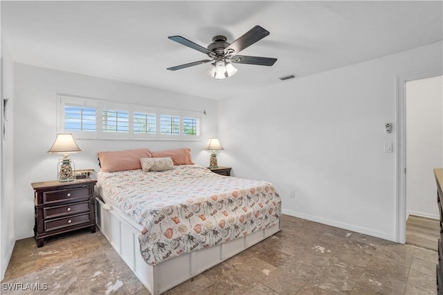 bedroom with visible vents, baseboards, and ceiling fan