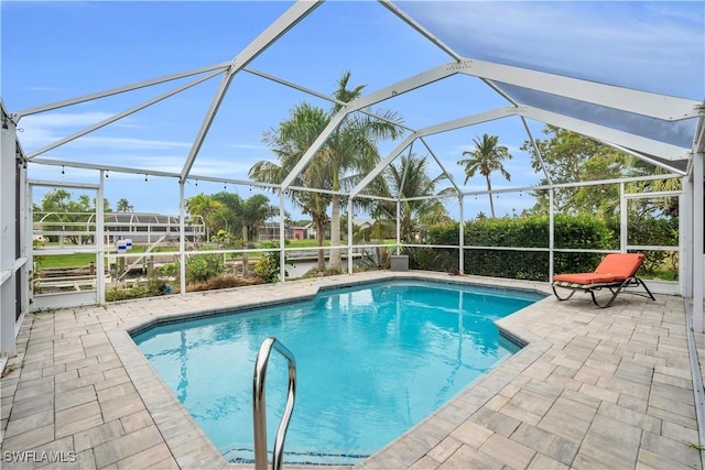 outdoor pool with a lanai and a patio