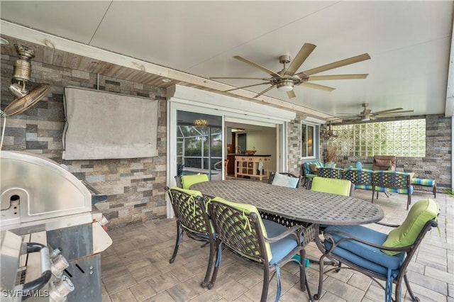 view of patio / terrace with a ceiling fan, outdoor dining area, and area for grilling