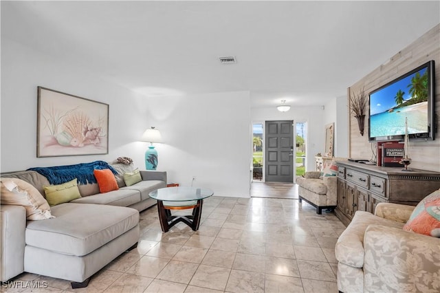 living room featuring light tile patterned floors and visible vents