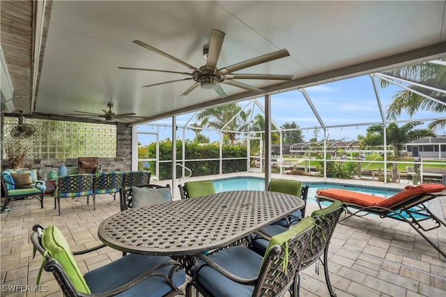 sunroom featuring a ceiling fan