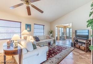 595 103rd Ave, Naples, FL 34108 - living room featuring a ceiling fan and lofted ceiling