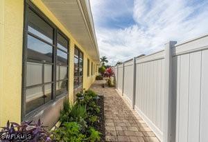 595 103rd Ave, Naples, FL 34108 - view of side of property featuring fence